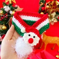 Detail of hand-knitted Christmas pet scarf with Santa Claus motif and red white green stripes - Santa Claus Red White Green