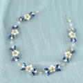 Detailed close-up of bridal headpiece with white pearls and blue crystals on gold wire - Blue Crystal Gold Wire