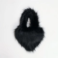 Detail view of heart-shaped black faux fur handbag with thick fibers and plush handle - Small / Black