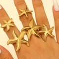 Detailed macro view of gold starfish rings showing polished and grainy metal textures - Starfish 5-Piece Style (56) / 5 Pieces / Gold