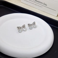Elegant silver bow knot stud earrings displayed on a white ceramic plate for a minimalist look - Silver Bow Stud Earrings Pair / Silver
