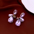 Detail of purple faceted teardrop earrings with colorful crystals on dark velvet - Gold Base Purple (Silver Pin) / Purple