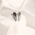 Silver open ring with black enameled wing design on a white textured stone base - Adjustable Open / Steel Color Wings Black