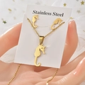 Detailed view of golden stainless steel seahorse pendant necklace and earring set - TT-042 Seahorse / Gold
