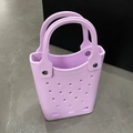 Close-up of lilac EVA beach bag showing waterproof hollow holes and silver rivet details - Purple