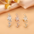 Detailed macro view of star-shaped zircon cartilage studs in silver, gold, and rose gold - Style 6