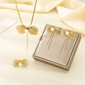 Detailed view of golden butterfly jewelry set with pearls on elegant silk background - Bowknot Tassel Pearl Style (KS225377-LX)