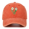 Detail of floral embroidery and washed cotton texture on a retro baseball cap - Orange