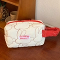 Detailed macro of the quilted cotton fabric and rabbit embroidery on this cosmetic bag - White Wristlet Bag