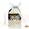 Macro detail of laser-cut heart pattern on silver favor box with blue satin ribbon - Reflective Silver