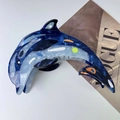 Detail of dolphin acetate hair claw with marble texture and ocean theme design - Dolphin