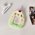 Detail view of plush cartoon dessert card holder with cherry charm and hanging hook - Yellow