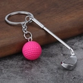 Creative silver golf club keychain with a mini pink ball on a stylish rustic background - Rose Red