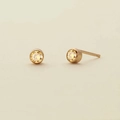 Macro shot of 18K gold plated zircon stud earrings with yellow round gemstones - November Light Yellow - Gold