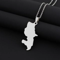Close-up of a silver Martinique map pendant necklace on a black textured surface - Steel Smooth