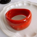 Irregular resin bangle in bright red with smooth finish and subtle marble texture - Pure Red Glossy
