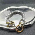 Detailed view of Viking wolf head charms on Franco Link bracelet with gold accents - 21cm / Silver-Gold Wolf Head