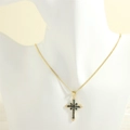 Detail of cross pendant necklace with blue stones on a mannequin display - Gold Snake Chain / Blue Zircon
