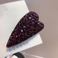Macro view of a deep red heart-shaped hair clip with sparkling rhinestones on card - Fuschia