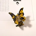 Macro shot of tortoiseshell butterfly hair claw clip with amber acetate pattern texture - Dark Coffee Butterfly Claw