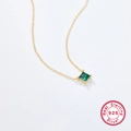 Detail of 925 sterling silver gold necklace with square green zircon pendant and four-prong setting - 925 Silver / Gold/Green Zirconia