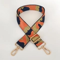 Detail of adjustable camouflage bag strap with orange patterns and gold metal lobster clips - Orange Gold Thread + Gold Buckle
