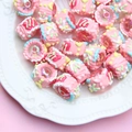 Detailed macro view of colorful resin cake beads with intricate pastel icing details - Transparent Bead + Pink Cream + Yellow Heart