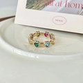 Adjustable golden ring with colorful enamel heart stones on a white ceramic tray - Multicolor Heart Gem (J3289)