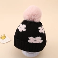Detail of baby winter knit hat featuring pink floral pattern and large soft pom-pom - 0-12 Months / Black