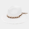 Detail of white straw sun hat featuring frayed edges and bohemian woven band decoration - One Size / White
