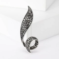 Broche feuille vintage en métal noir avec strass gris foncé sur un socle blanc - Noir