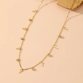 Detail shot of golden necklace featuring alternating key pendants and sparkling crystals - Key Style (L406)
