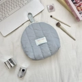Macro detail of a soft quilted shell makeup bag in light blue with Sorakka Studio label - Light Blue