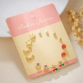 Titanium steel earring set with heart, pearl, and bow designs on a display card - Gold Crown Letters (E1890-1)