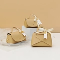 Beige faux leather wedding favor bags with gold handles and decorative love ribbons - Beige