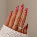 Press on nails with cat eye finish in deep pink worn with gold and silver rings - Deep Peach Glitter Style (XC-24-12)