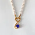 Collier de perles élégant avec fermoir cœur, pierre bleue et pendentif éventail doré - Lettre L