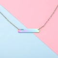 Detail of rainbow stainless steel bar necklace with hollow heart on colorful background - Rainbow