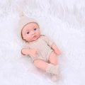 20cm lifelike reborn baby doll in beige knit outfit on soft white faux fur background - Off-white Sweater