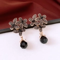 Macro shot of vintage floral earrings with grey rhinestones and black faceted glass drops - Silver Earring Post - Gold - Black
