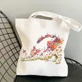 White canvas tote bag featuring an artistic floral cat illustration and sturdy straps - C6 Creamy Cat