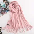 Pink faux cashmere scarf with fringe and brand label shown in flat lay arrangement - Baby Pink