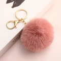 Pink faux rabbit fur pompom keychain with golden metal clasp on a stylish white book - Dusty Pink / Elastic Band (No Hardware)