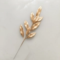 Detailed view of champagne gold glitter branch leaf for Christmas tree decoration - Painted Gold