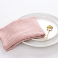 Pink cotton linen dinner napkin displayed on white ceramic plates with a golden spoon - Lotus Pink