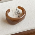 Minimalist wide open resin bangle in translucent amber brown with a retro organic shape - Style 54