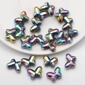 Macro view of colorful butterfly-shaped glass beads with iridescent metallic luster for DIY - Multicolor