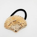 Detailed shot of golden metal starfish and shell design on black elastic hair tie - Starfish Shell Relief (Hair Tie 14)
