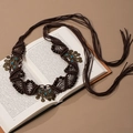 Macro detail of Bohemian woven waist chain with turquoise beads on vintage book pages - Antique Bronze Crescent Tassel Deep Coffee (X451-3)