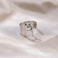 Silver open adjustable ring featuring a large hollow letter R on champagne silk fabric - Letter R / Silver